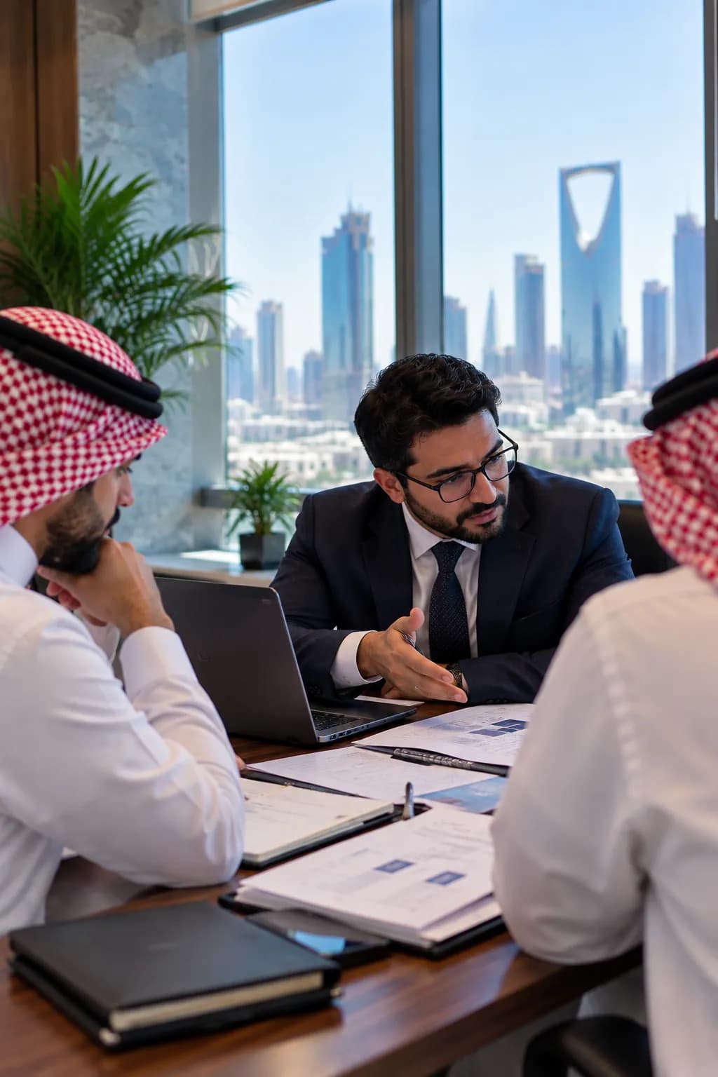A consultant talking a governance document through with a client team across a meeting table