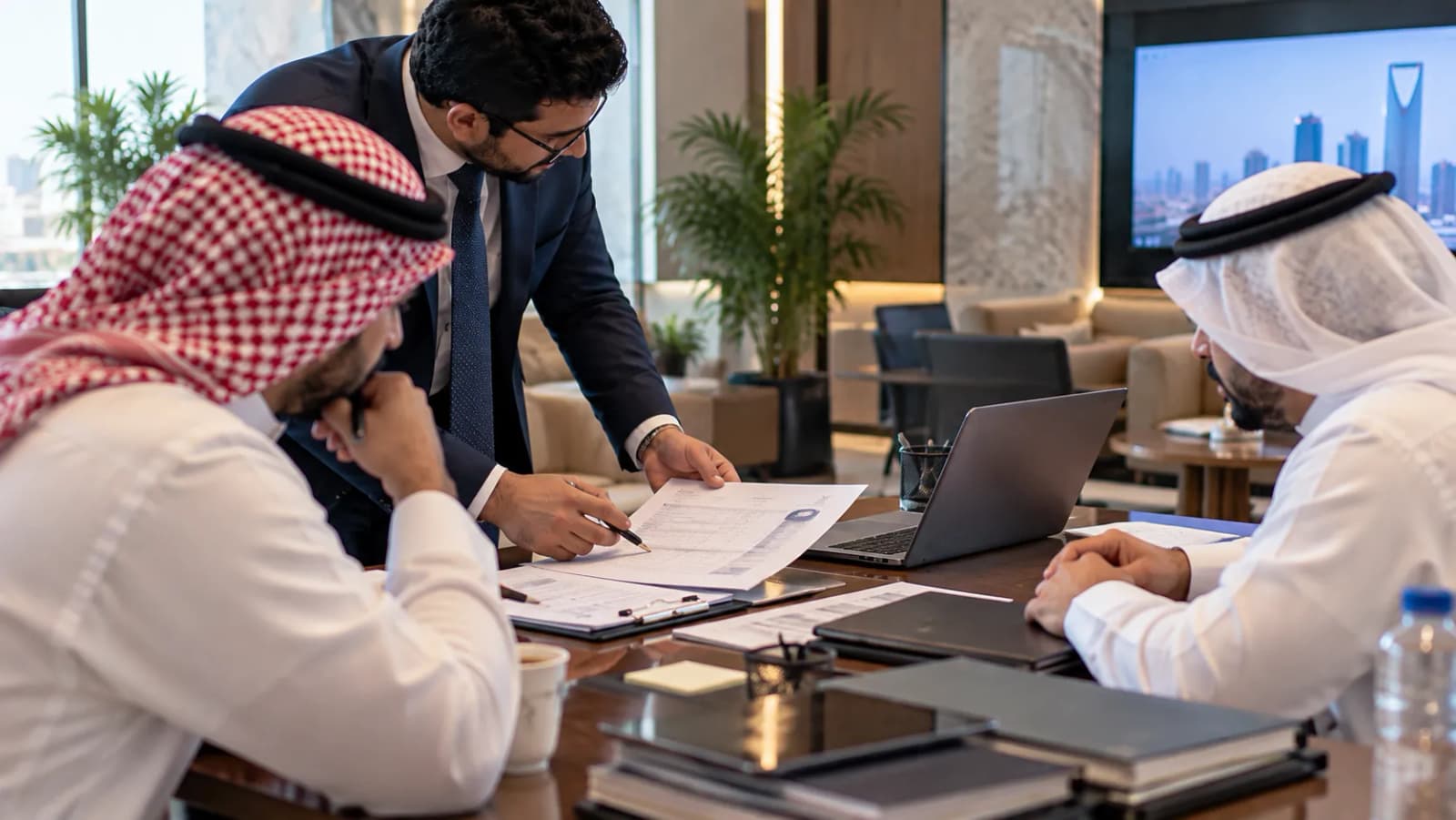 A consultant standing at a boardroom table